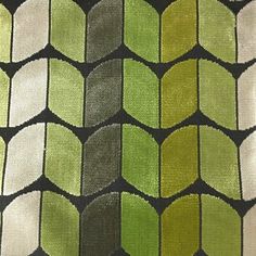 an upholstered green and black fabric with geometric shapes