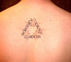 the back of a woman's neck with a tattoo that reads, green cupcake wilson