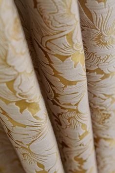 closeup of curtains with gold and white designs