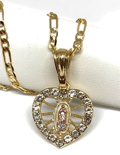 Brand new 24 inch gold laminated chain with Virgin Mary CZ pendant.Beautifully designed to look identical to the 14k Mexican Pendant.Chain is 24 inches 4mm.Comes packaged inside an individual box. Mexican Necklaces, Virgin Mary Heart, Mary Heart, Gold Neck Chain, Latina Jewelry, Christian Accessories, Dope Jewelry Accessories, Pretty Jewelry Necklaces, Quince Ideas