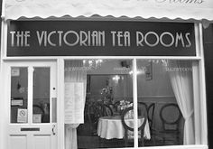 the victorian tea rooms in black and white is open to let people know where they are going