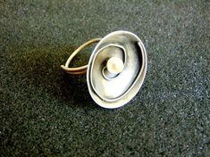 Beautiful women's statement ring. It is made completely out of sterling silver (aka silver 925 each piece is stamped), with a small round pearl in its center...------> If you do not know, or you are not sure about your ring size, the ring will be adjustable<----------->A useful guide to help you determine your ring size: http://www.ringsizes.co/ <------This beautiful ring is brought to you by Filigrane jewelry lab that we have the pleasure of working with! Modern Silver Pearl Ring As Gift, Modern Silver Pearl Ring For Gifting, Modern Sterling Silver Pearl Ring For Gift, Modern Sterling Silver Pearl Ring As Gift, Unique Sterling Silver Pearl Ring In Silver, Unique Sterling Silver Pearl Ring, Unique Silver Oval Pearl Ring, Unique Silver Pearl Promise Ring, Unique Silver Pearl Ring