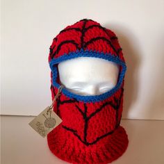 a crocheted spider man hat with a tag on it