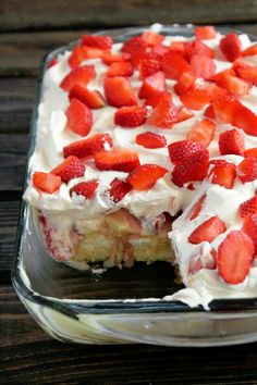 a cake with strawberries on top in a glass dish