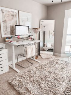 a computer desk sitting on top of a white rug