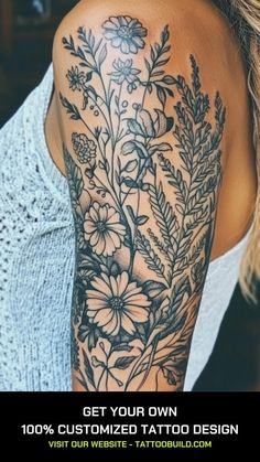 a woman's arm with flowers and leaves tattooed on the back of her shoulder