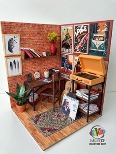 a miniature model of a room with furniture and pictures on the wall