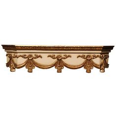 an ornate gold and white wall shelf