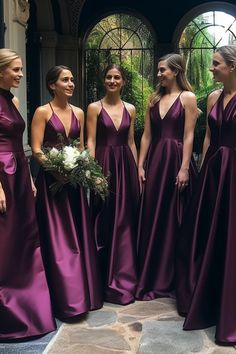 a group of women standing next to each other wearing purple dresses and holding bouquets