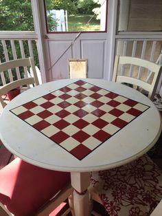 a checkered table and chairs on a porch