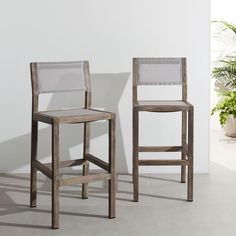 two wooden chairs sitting next to each other