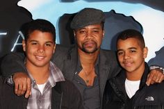 three young men posing for a photo together