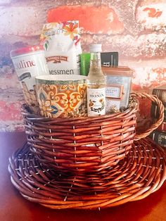 a wicker basket filled with liquor and snacks