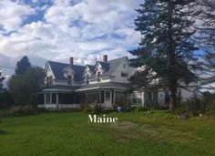 a large house sitting on top of a lush green field