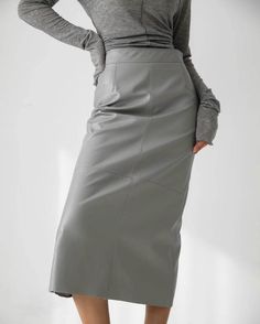 Chic, stream lined pencil midi skirt in faux leather. - Small fits sizes 25-26, Med fits sizes 27-28- Zip closure- Midi length- Back slit- Small waist 26", length 31", hips: 35"- Med waist 28.5", length 32", hips 38"- Faux leather 100%- Dry clean or machine wash cold and line dry- Imported Pu Skirt, Metallic Pleated Skirt, Pencil Skirt Work, Gauze Skirts, Mid Calf Skirt, Solid Skirt, Ankle Length Skirt, Grey Pencil Skirt, Bubble Skirt