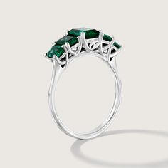 Spectacular. Stunning. Unforgettable. In our new Alexandrina ring we created a goldsmith masterpiece unlike anything else. Five large and deep-green emeralds are elevated above the ring with an elegant bridge decorated with our signature sign, forming an architectural perfection on your finger. It's not just a bling, the skilled craftsmanship and unique design turn the Alexandrina ring into a true heirloom that will never go out of style and will be passed through generations. **Due to the nature of the natural Emerald the color may vary** All features can be customized! please contact us if you wish to make changes, we love making custom designs. All of our jewelry is carefully handmade in our atelier *HC diamond are all conflict free diamonds To order by phone click here>> +972(0)7229910 Timeless Green Emerald Ring With Center Stone, Formal Emerald Rings Fine Jewelry, Luxury Emerald Cluster Ring For Promise, Luxury Emerald Cluster Promise Ring, Emerald Cut Green Gemstone Cluster Ring, Luxury Emerald Birthstone Ring For May, Timeless Emerald Cut Sterling Silver Emerald Ring, Emerald Ring With Baguette Cut For Formal Events, Emerald Cluster Ring With Brilliant Cut