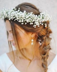 a woman wearing a flower crown with long hair