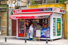 two people standing in front of a store