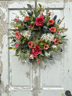 an old door with a wreath on it