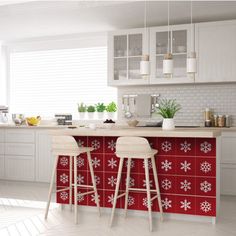 two stools are sitting at the bar in this white and blue kitchen with tile backsplash