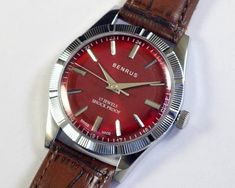 Vintage Benrus Swiss Made Hand Winding Mens Wrist watch | red dial | mechanical | stainless steel | gift for men for him This restored vintage watch has undergone professional cleaning, polishing, servicing, and oiling and is now ready to use  . Watch case diameter is 35mm without the crown and the lug size is 18mm . The watch features a new aftermarket case, dial, hands and band/strap, while retaining its original movement. . Provided pictures are an integral part of the item description, capturing every detail for your assessment. . Any defects not mentioned in the description but can be seen in the pictures will be considered as described. . Mechanical watches naturally exhibit slight variations in timekeeping. Please allow for a few minutes' deviation per day. . Watch has been tested f Timeless Red Watch Accessories, Timeless Red Watch With Analog Display, Classic Red Analog Watch, Classic Red Watch As A Gift, Classic Red Watch As Gift, Classic Red Watch Accessories For Gift, Classic Red Watches As Gift, Classic Red Watch Accessories As Gift, Classic Red Watch Accessories As A Gift