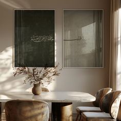 a dining room table with four chairs and two pictures on the wall above it that have arabic writing