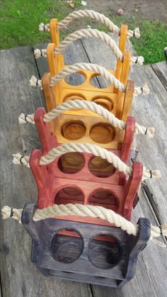 three wooden toys stacked on top of each other with ropes and eye glasses attached to them