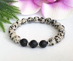 All of my items are made with genuine, natural stones and crystals. Please be aware that no two stones are alike, that is what makes them unique. The size, colour and patterns of the beads will vary from piece to piece but these variations will not compromise the energy, beauty, and quality of your bracelet. This elegant black and white Dalmatian Jasper bracelet is a beautiful way to diffuse your favourite essential oils. This lava bead bracelet is made with genuine 8mm dalmatian jasper gemstone Casual Natural Stone Crystal Bracelet As Gift, Casual Crystal Bracelet With Natural Stones For Gift, Casual Crystal Bracelet With Natural Stones As A Gift, Casual Stretch Bracelet With Natural Stones For Gift, Casual Natural Stones Stretch Bracelet Gift, Casual Beaded Stone Bracelets For Gifts, Casual Adjustable Beaded Bracelets With Stones, Dalmatian Bracelet, Beaded Ankle Bracelets