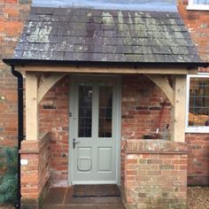 an old brick building with a green door