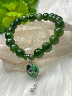 Material: Nephrite Jade+ Jade Money Pouch charm  Bead (Nephrite) diameter: 9.3MM Fox charm: Jade Wrist size: 16.5CM/6.1/2" ** NOTE**--We do our utmost taking photos to be the same as the actual item, however, the color may vary from monitor to monitor. NO enhancement of the color or texture. Kindly feel free to contact us for more photos or with any questions prior to your checkout. We are always very happy to help you. Crystal healing uses Nephrite Jade can harmonise the energy of the adrenals, Spiritual Round Rosary Bracelet With Polished Beads, Jade Crystal Bracelet With Gemstone Beads For Healing, Jade Bracelets With Polished Beads As A Gift, Jade Bracelets With Polished Beads For Gifts, Spiritual Jade Beaded Bracelets With Polished Beads, Holistic Jade Beaded Bracelets, Healing Gemstone Rosary Bracelet, Spiritual Jade Crystal Bracelet With Gemstone Beads, Green Round Crystal Bracelet For Spiritual Use