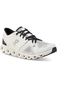 the on cloud running shoe is white and black