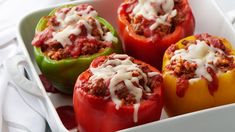 four stuffed tomatoes on a plate with parmesan cheese