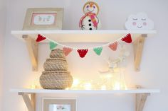 a shelf with some decorations on top of it and lights underneath the shelves in front of them