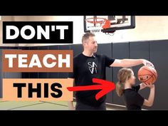 a man holding a basketball while standing next to a woman in front of a basketball hoop