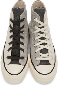 High-top paneled canvas and brushed felt sneakers colorblocked in off-white and tones of grey. Round rubber cap toe. Mismatched lace-up closure in black and off-white. Bonded logo patch in white and eyelet vents at inner side. Felted trim in dark grey at heel. Rubberized stripe in black at welt. Tonal rubber midsole featuring black stripe and black rubber logo patch at heel. Treaded rubber outsole in brown. Silver-tone hardware. Available exclusively at SSENSE. Supplier color: Turbulence/Tofu/Eg White Chuck Taylors, Run Star Hike, Silver Sneakers, Converse White, High Sneakers, Chuck 70, Low Sneakers, Sneaker Collection, Converse High Tops