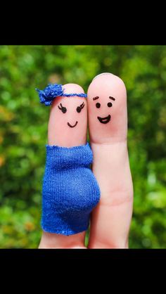 two fingers with faces drawn on them, one is holding the other's hand