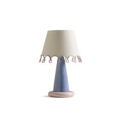 a table lamp with a blue base and white lampshade on the top,