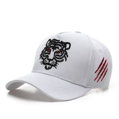 a white baseball cap with a black and red tiger on it