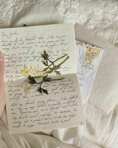 someone is holding an old letter with flowers on it