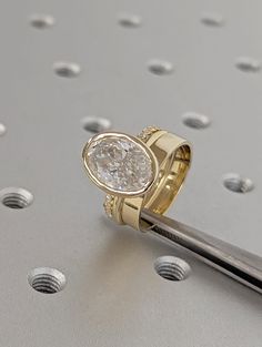 a gold ring with a white diamond on it