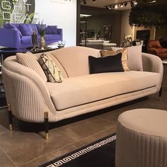 a living room with couches and chairs on display in front of a large window