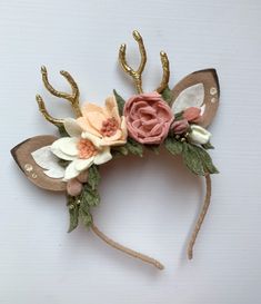 a headband with flowers and antlers on it