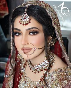 a woman with makeup and jewelry on her face