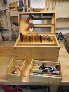 a workbench filled with tools and wooden boxes