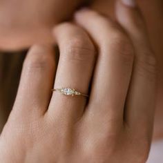 a woman's hand with a diamond ring on it