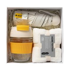 the baby gift set includes a bottle, diaper and wipes in a box