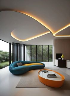 a modern living room with an orange and blue couch, round coffee table and large windows