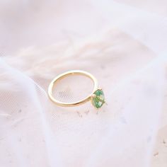 This solitaire ring features a vibrant oval green tourmaline, securely held in a classic 4-prong setting on a delicate 14k gold band. Material: Solid 14-karat gold Gold Colors: Yellow, rose, or white gold Main Gemstone: Oval green tourmaline, 8 x 6 mm Setting: Classic 4-prong Band Width: 1.75 mm A timeless and elegant piece that brings a pop of color to any occasion. Oval Solitaire Tourmaline Jewelry, Oval Tourmaline Solitaire Jewelry, Elegant Oval Tourmaline Emerald Ring, Oval Emerald Ring In Yellow Gold For Proposal, Oval Yellow Gold Emerald Ring For Proposal, Oval Tourmaline Ring For May Birthstone, Classic Solitaire Tourmaline Ring, Minimalist Oval Green Emerald Ring, Oval Emerald Ring In 14k Gold For Proposal