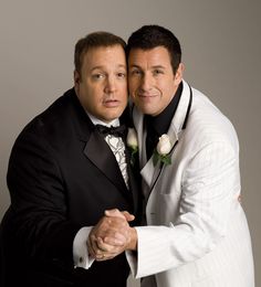 two men dressed in tuxedos pose for a photo with their arms around each other