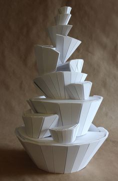 a stack of white bowls sitting on top of each other